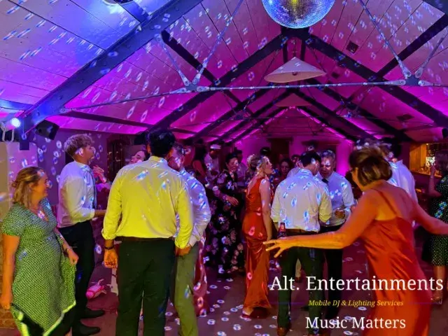 Guests dancing and enjoying a lively wedding reception at Grangefields Barn, Ashbourne, Derbyshire, with professional DJ and entertainment services by Alt. Entertainments, a Wedding DJ and Mobile DJ Company.