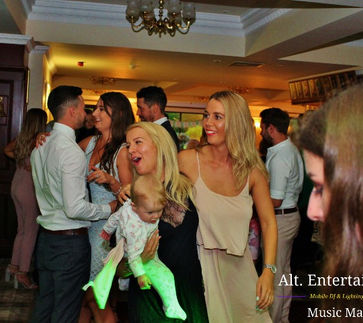 A joyful scene of wedding guests dancing under the stars at a disco reception in Beau Desert Golf Club, Cannock, Staffordshire, surrounded by love and laughter.
