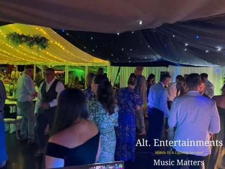 Wedding guests dancing and celebrating at Quaint Country Weddings in Welshpool, Powys, Wales. Photo taken by Alt. Entertainments, a professional wedding DJ and mobile DJ events company, providing music and entertainment for weddings and parties.