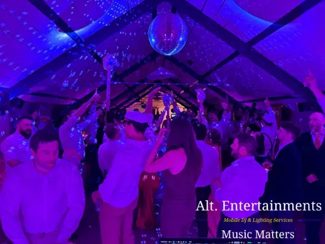 Wedding guests dancing and celebrating at Grangefields Barn in Ashbourne, Derbyshire, with professional wedding DJ and mobile event services provided by Alt. Entertainments.