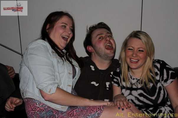 A group of friends posing for a photo at the Revolved Indie Night Reunion in Wolverhampton. Captured by Ilt. Entertainments, an Indie DJ, Mobile DJ, Disco & Events Company, the image reflects the lively and celebratory atmosphere of the event. The Light Bar's energetic and nostalgic ambiance serves as a backdrop, enhancing the sense of camaraderie and shared joy among the friends. The photograph captures the essence of the indie music scene and the lasting impact of such memorable gatherings.