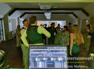 Wedding guests dancing joyfully at a vibrant wedding disco at Gellifawr Woodland Retreat, Fishguard, Wales. The photo showcases the lively atmosphere, with guests immersed in music provided by Alt. Entertainments’ mobile DJ setup, set against the serene woodland backdrop.