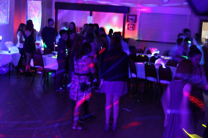 Vibrant dancers light up the dance floor at a birthday disco hosted by Alt. Entertainments in Blymhill & Western Under Lizard Village Hall. An energetic celebration captured in a dynamic photograph.
