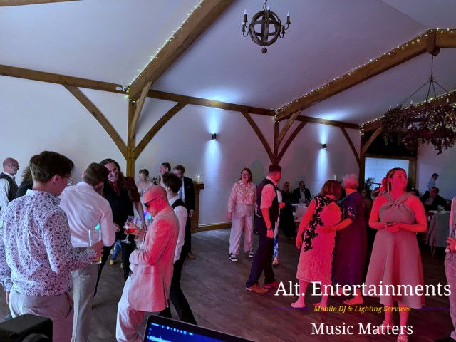Colorful dancers performing joyfully at Coton House Farm wedding, photographed by Alt. Entertainments Wedding DJ/Mobile DJ, Disco & Events Company in Whittington, Lichfield, Staffordshire.