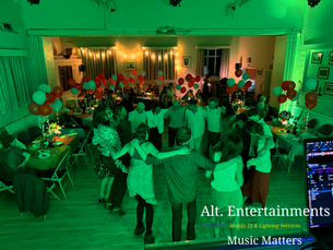 Guests dancing on a busy dancefloor at a birthday party at Woodhouse Eaves Village Hall in Leicestershire, with DJ entertainment, music, and lighting by Alt. Entertainments.