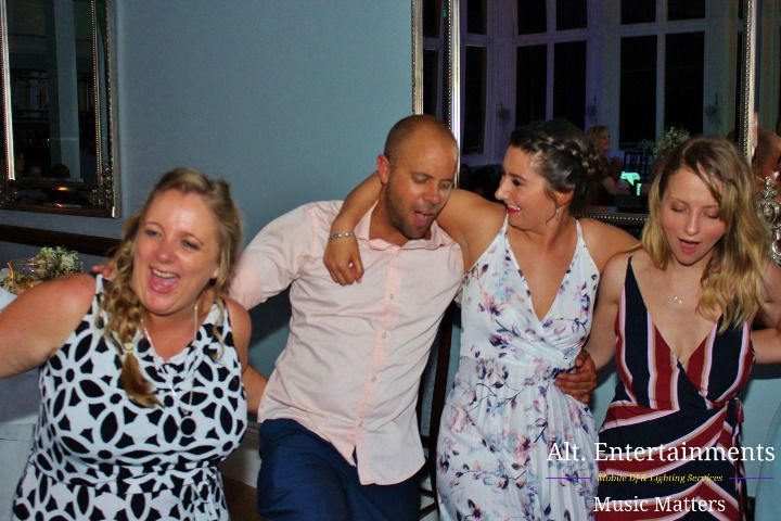 A heartfelt moment as wedding guests share the last dance at Pendrell Hall's enchanting wedding disco, captured by Alt. Entertainments, a premier Wedding DJ/Mobile DJ, Disco, and Events Company.