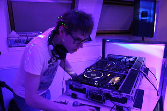 A mobile DJ commands the turntables, captivating the audience with a spellbinding performance at Solihull Moors Football Club, captured by Alt. Entertainments, a mobile DJ & Disco Company.