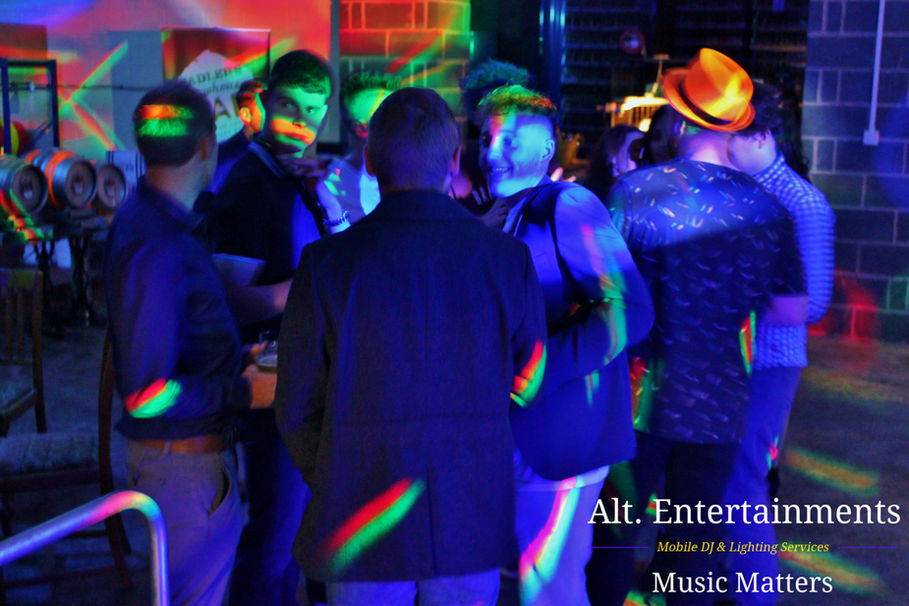 A dynamic crowd dances with euphoric energy at Sadlers Brewery Stourbridge, captured by Alt. Entertainments, a top-tier mobile DJ, Disco & Events company, illuminating the dance floor with vibrant excitement and joy.