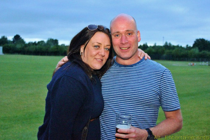 A vibrant and energetic crowd dancing at a party at Crewe Vagrants Sports Club in Nantwich, Cheshire. The photo, taken by Alt. Entertainments, shows guests enjoying the lively atmosphere with colorful lighting and dynamic effects, reflecting the high-energy ambiance of the event.