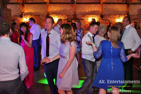 A jubilant crowd dances energetically at a wedding reception in Mercure Madeley Telford, Shropshire, with Alt. Entertainments, a premier mobile DJ, wedding DJ, disco, and events company, providing the vibrant musical backdrop.