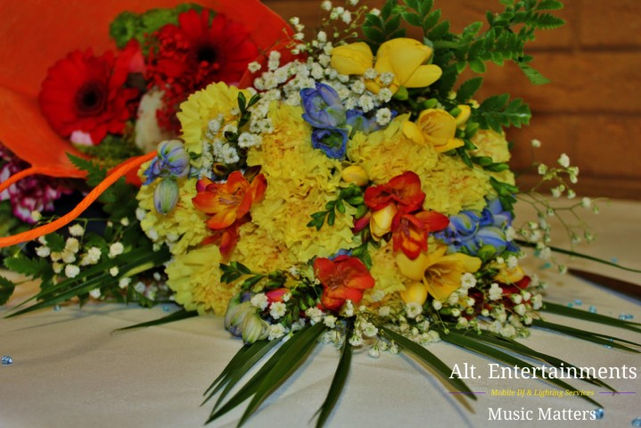 A stunning display of wedding flowers adorns the Wellington Civic & Leisure Centre in Telford, Shropshire, captured in this enchanting photograph by Alt. Entertainments, a trusted Wedding DJ / Mobile DJ, Disco & Events Company.