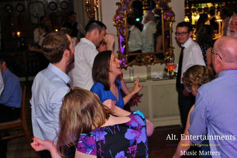 A lively crowd of guests dancing at a wedding disco held at Merewood Country House in the Lake District, Cumbria. The photo, taken by Alt. Entertainments, a wedding DJ and mobile disco company, shows an energetic dance floor with guests enjoying the music, set against the elegant backdrop of the venue.