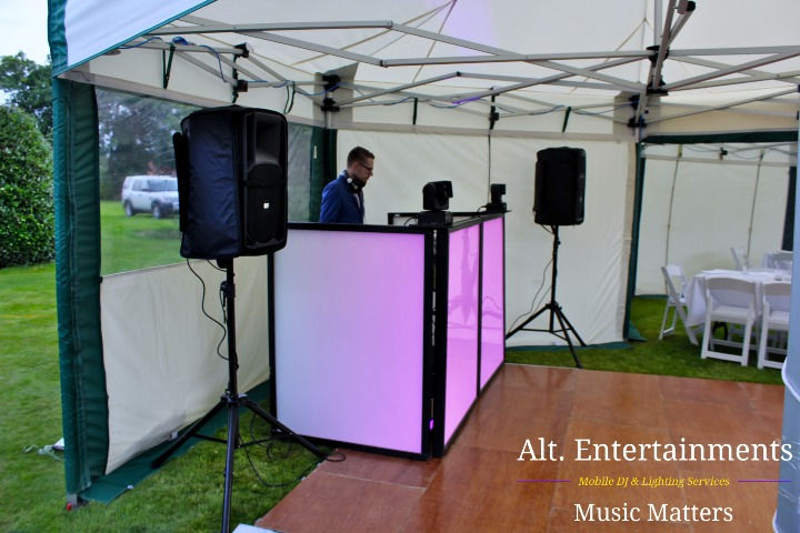 An impressive DJ setup at a private party in Newark-on-Trent, Nottinghamshire, arranged by Alt. Entertainments, a leading mobile DJ, disco, and events company. The setup features high-powered speakers, advanced mixing consoles, and dynamic lighting equipment, creating an immersive auditory and visual experience. The sleek DJ booth and vibrant lights enhance the party atmosphere, ensuring an unforgettable celebration.