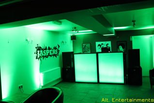 A captivating view of a mobile DJ setup illuminated in green light, casting an enchanting ambiance at Jaspers in Shifnal, Telford. Photograph courtesy of Alt. Entertainments, a trusted mobile DJ, Disco, and Events company.