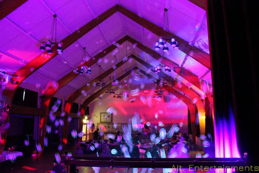 UV bubbles illuminated by ultraviolet lighting at Middlewich Civic Hall, Cheshire. The photo, taken by Alt. Entertainments, highlights the magical effect of the glowing bubbles and demonstrates the company's skill in creating enchanting and visually impressive event environments.