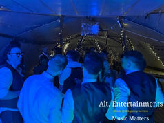 Wedding guests dancing to indie, punk, and rock music inside a rustic tipi at Newlands Bishop Farm in Solihull, DJed by Alt. Entertainments.