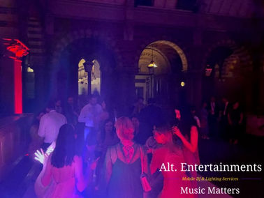 Guests dancing with enthusiasm at a wedding reception in the Carriage Court at the Renaissance at Kelham Hall, Newark, Nottinghamshire. The photo, taken by Alt. Entertainments, showcases the lively atmosphere created by their Wedding DJ/Mobile DJ, disco & events company.