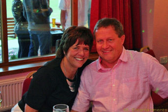 A vibrant party scene at Crewe Vagrants Sports Club, Nantwich, Cheshire, featuring a lively crowd dancing and enjoying the event. The photo, taken by Alt. Entertainments, showcases the energetic atmosphere, colorful lighting, and festive ambiance of the party, emphasizing the company's role in delivering top-notch entertainment.