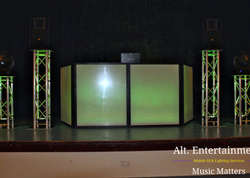 A professional DJ setup illuminates the stage with vibrant lights at Featherstone & Hilton Community Centre, creating an electrifying ambiance.