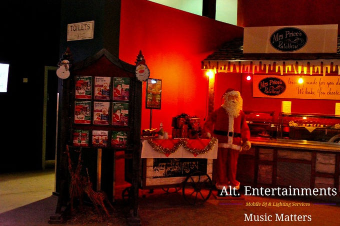 Festive Christmas-themed DJ setup at Twycross, Little Oulton, Leicestershire, featuring twinkling lights, garlands, and top-quality sound equipment. Captured by Alt. Entertainments, a mobile DJ, disco, and events company, the setup promises a joyful and memorable holiday event.
