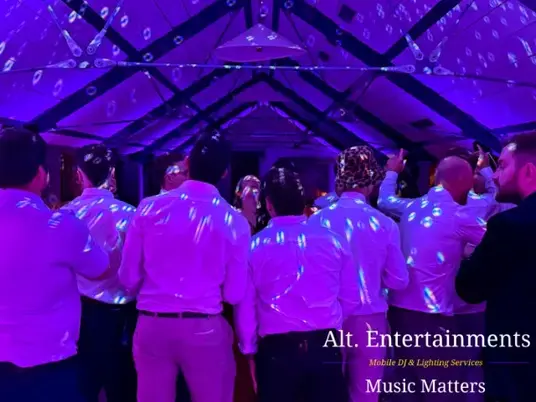 Wedding guests dancing joyfully on the dance floor at Grangefields Barn, Ashbourne, Derbyshire. Professional DJ services by Alt. Entertainments, a Wedding DJ, Mobile DJ, and Events Company.