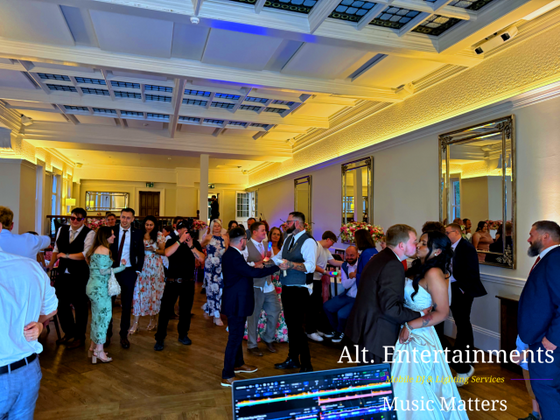 Newlyweds sharing their first dance at Pendrell Hall in Codsall Wood, Staffordshire, during their wedding reception, with music provided by Alt. Entertainments.