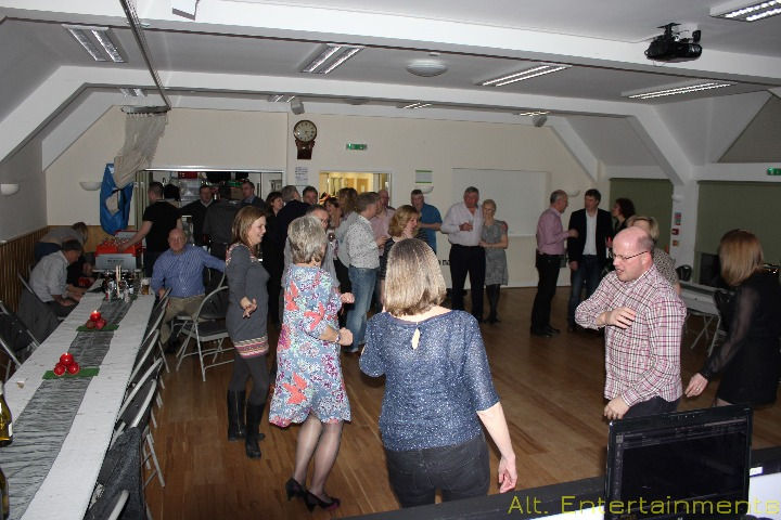 A vibrant photograph captures the lively atmosphere of a party at Meysey Hampton Memorial Hall, with guests dancing joyfully to the music. Taken by Alt. Entertainments, a mobile DJ, Disco & Events company, the image showcases the spirit of celebration and camaraderie in full swing.