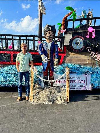 Jett Paxton with his statue at ShrimpFest