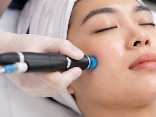esthetician performing a HydraFacial treatment on a client's skin