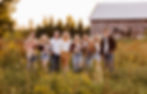 large family portrait in front of a barn