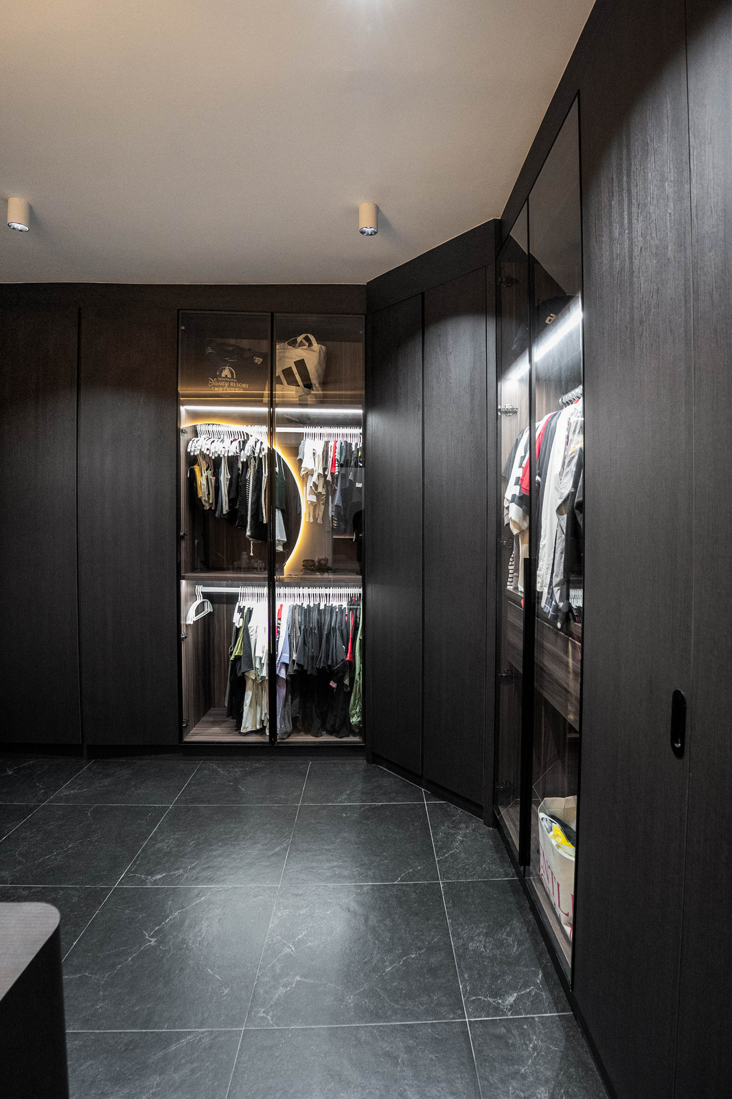 Dark wardrobe with lit glass cabinets