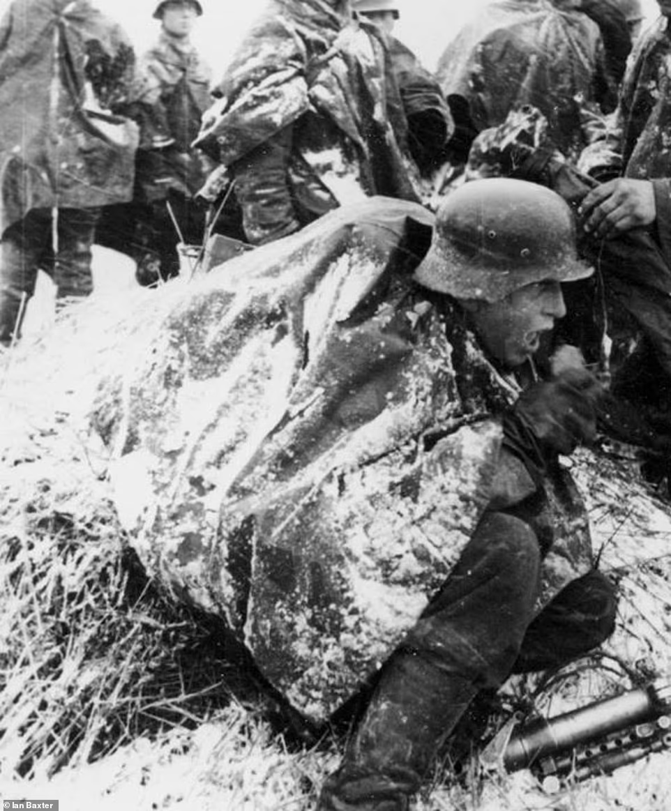 A frozen German is seen trying to keep warm during the Russian winter of 1941. @DailyMail