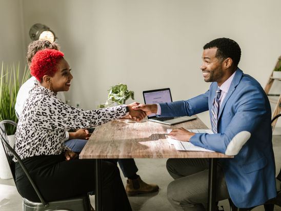 A couple in discussion with a male agent.