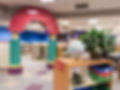 Modern library children's section with colorful reading nook and bookshelves
