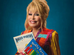 Dolly Parton, smiling, holding two books