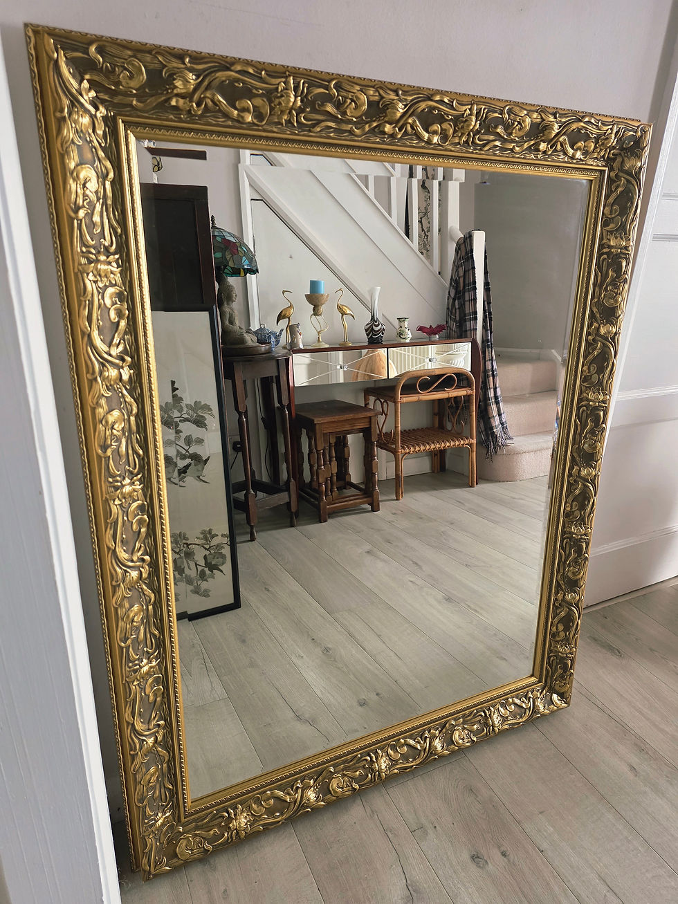 Very large bevelled wall mirror with elaborate gold frame