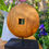 Thumbnail: Wood-mounted, circular 'wheel' ornament in warm mango wood