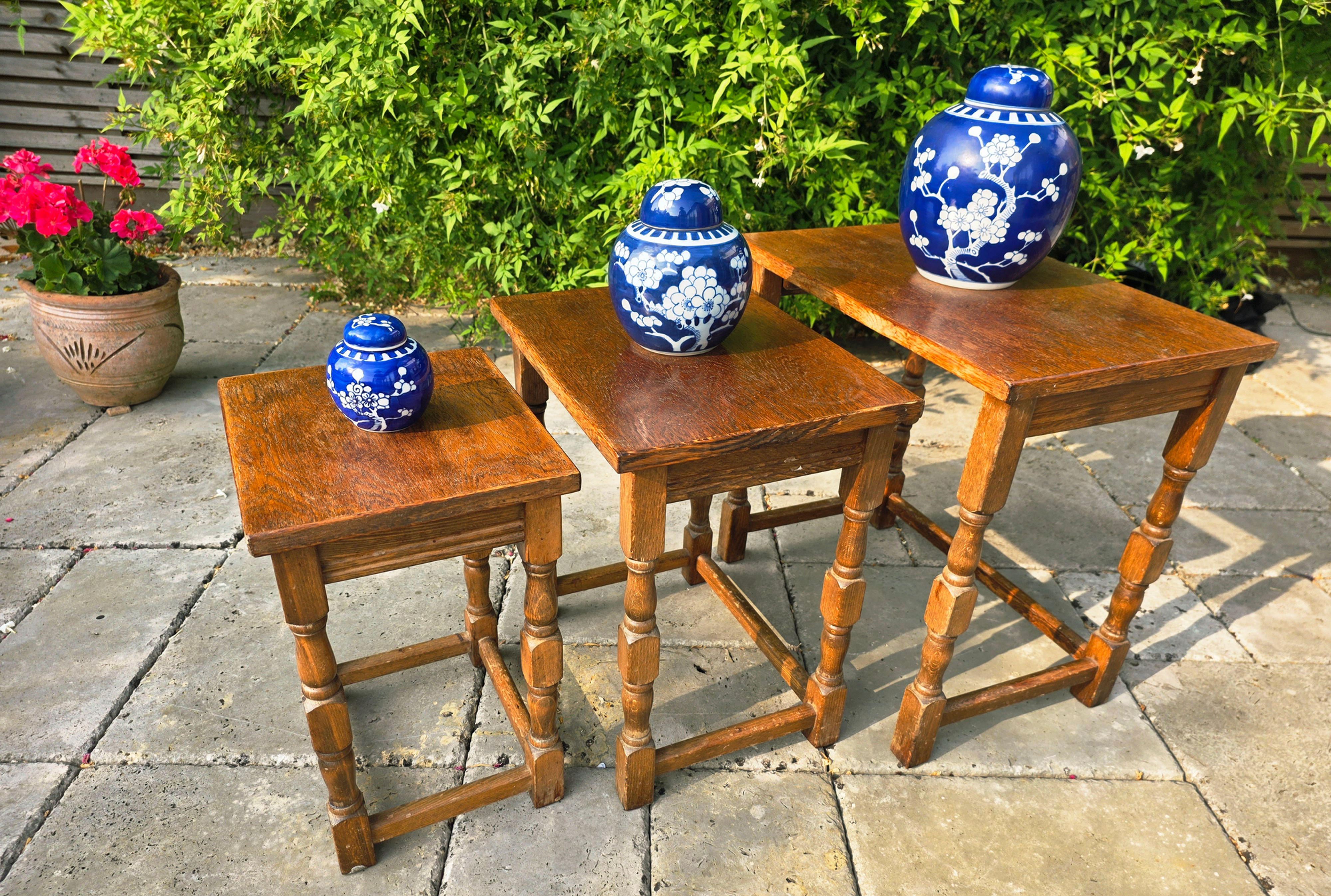 Nest of 3 solid oak coffee tables with turned legs, possibly antique