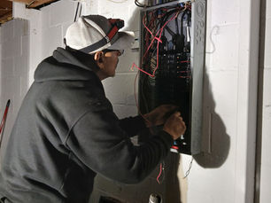 Lupe working on an electrical panel upgrade