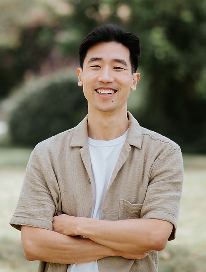 Samuel Shin, LMFT Headshot with arms crossed and nature in the background