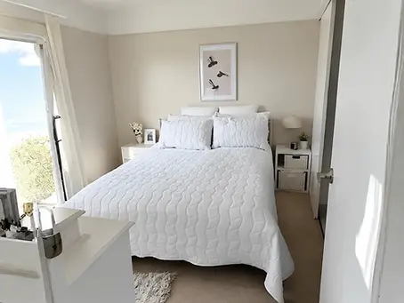 Bright retirement apartment bedroom at Cosmopolitan Village in Auckland