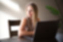 Alli Beck sits at a laptop, where she designs Wix websites
