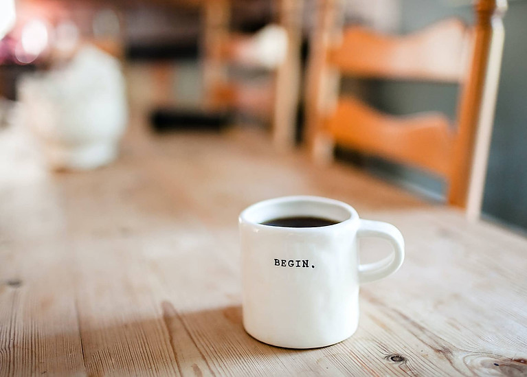 Coffee cup that says "begin"
