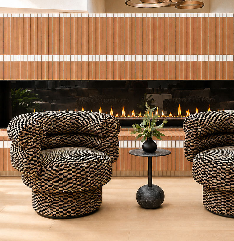 Sculptural patterned lounge chairs beside a linear fireplace
