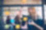 woman puts up post it notes in a brainstorming session with her team