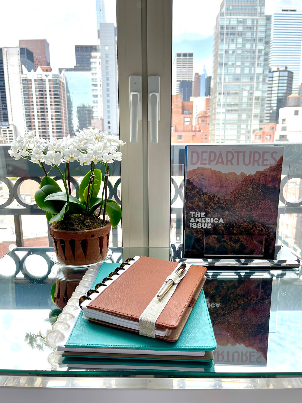 A desk with a planner on top