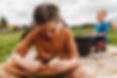 Student participating in outdoor education and hands-on learning during summer camp on the school farm
