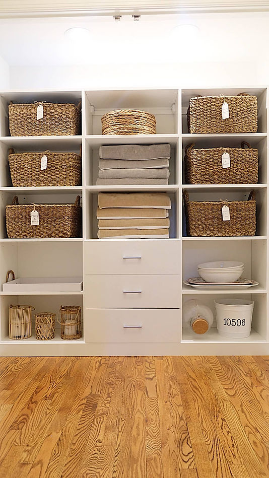 Hall closet organized with bins and baskets