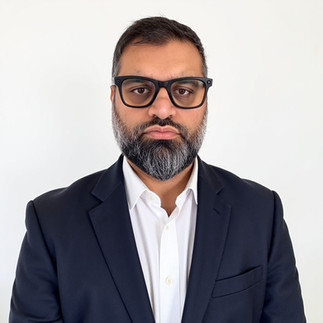 AI Headshot of Mil Patel in jacket and shirt on white background.