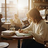 woman writing in cafe